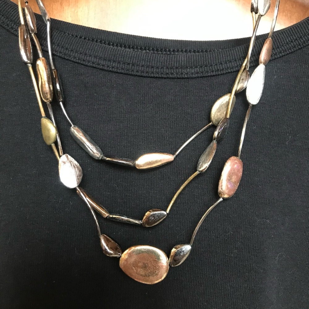 Chico’s 3 layer necklace with gold, copper, pewter and silver tone shapes.